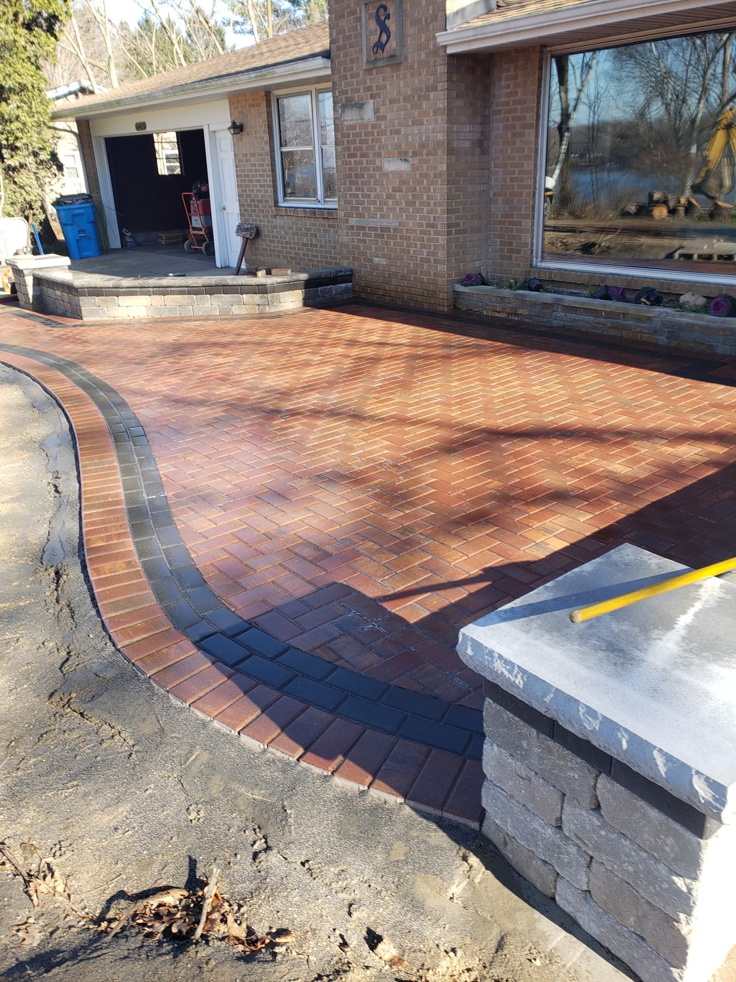 Curved red brick paver driveway and walkway