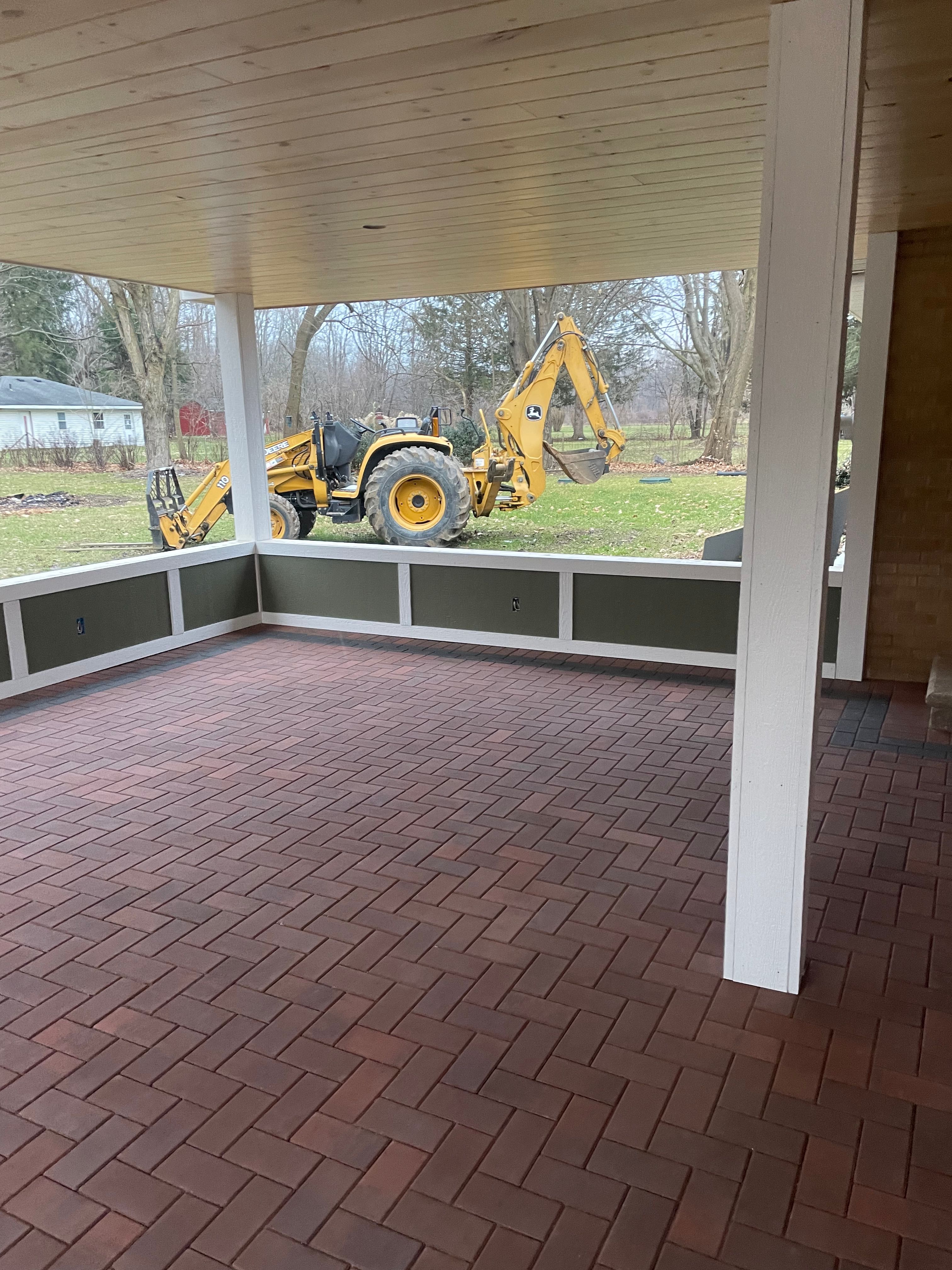 Completed covered porch with brick paver outdoor living space